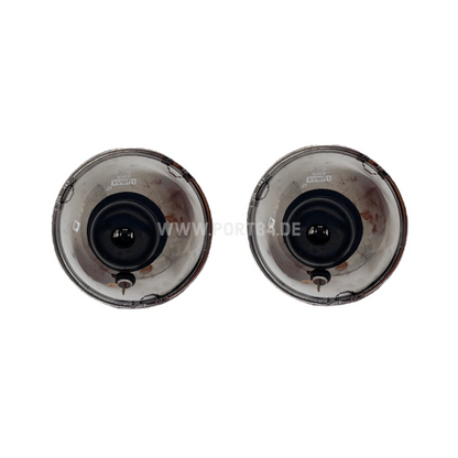 Two Volvo headlights with E-mark approval for models 140, 142, 144, 145, 242, 244, 245.